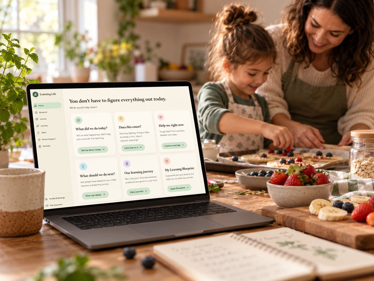 Learning Life open on a laptop while a mother and daughter bake together